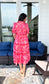 Back of pink floral print midi dress with sleeves